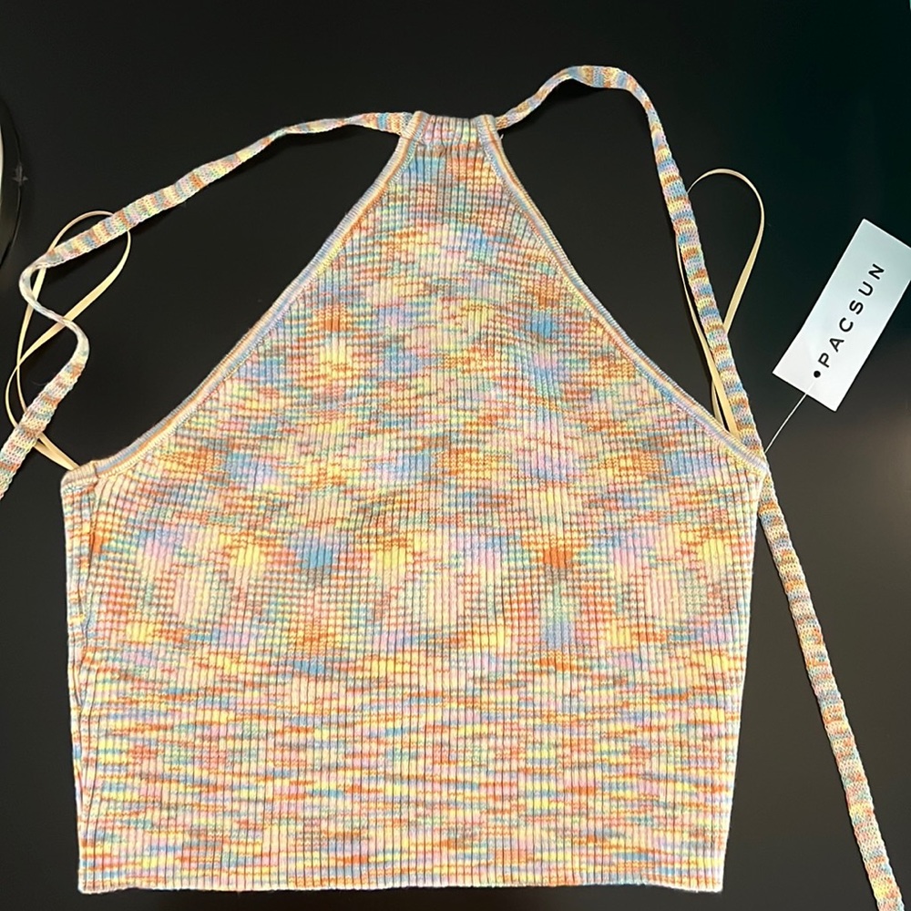 brand new pac sun tank with tags. ties around the neck and is cropped.